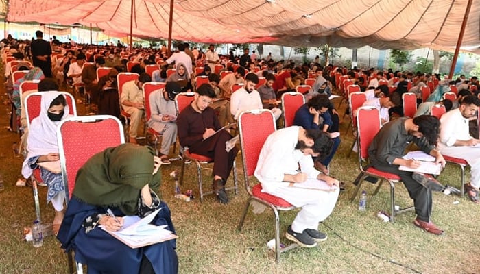 This image shows students attempting the MDCAT exam in the Khyber Medical University (KMU) examination hall on September 22, 2024. — X/@kmuofficial_