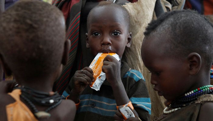 This representational image shows Turkana children eat food supplements given by Save the Children organization during outreach program in draught-hit Lorengo village, Kenya on July 19, 2022.— Reuters