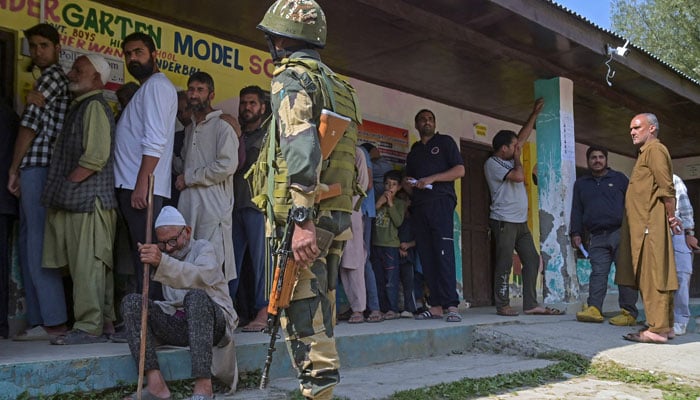 An elderly person waits for his turn as voters queue up to cast their ballots at a polling station during the second phase of voting for local assembly elections, in Ganderbal on September 25, 2024. — AFP