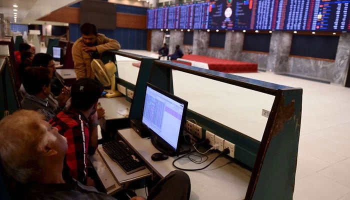 Stockbrokers watch the latest share prices during a trading session at the Pakistan Stock Exchange (PSX) in Karachi on February 3, 2020. — AFP/File