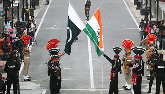 Pakistani Rangers and Indian Border Security Force (BSF) officers lower their national flags during parade at the Pakistan-India joint check-post at Wagah border, near Lahore on August 14, 2019. — Reuters