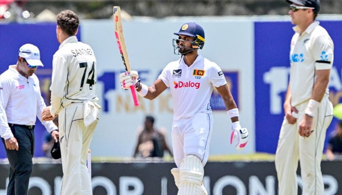 Sri Lankas Dinesh Chandimal celebrates reaching fifty against New Zealand in Galle on September 26, 2024. — AFP