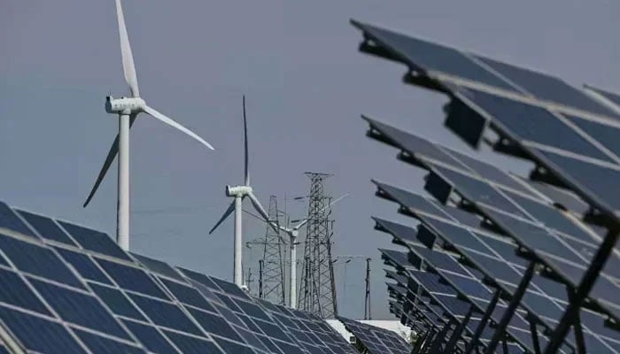 Electric power generating wind turbines and solar panels can be seen in this undated photo. — AFP/File