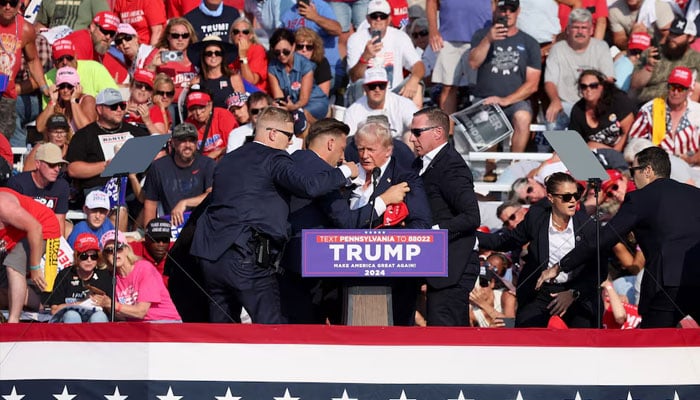 Republican presidential candidate and former US President Donald Trump is assisted by US Secret Service personnel after he was shot in the right ear during a campaign rally at the Butler Farm Show in Butler, Pennsylvania, US, July 13, 2024. — Reuters