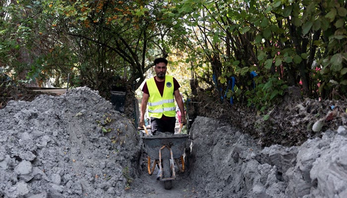 A migrant from the association of the Free Syrian Community Austria volunteers with the clean-up of the floods in Kritzendorf, Austria, September 26, 2024. — Reuters