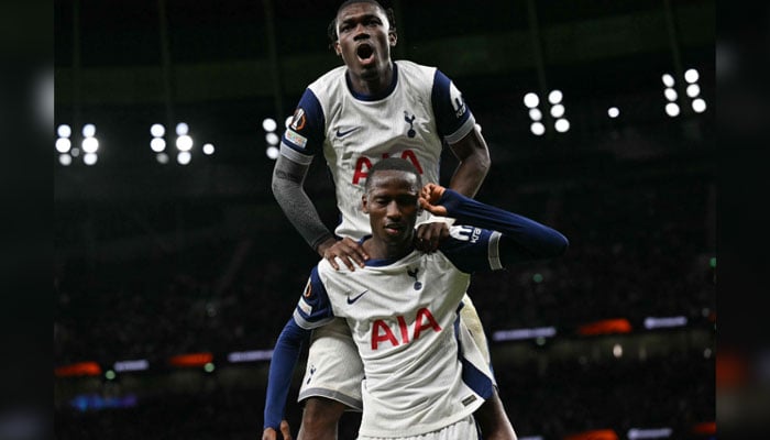 Tottenham Hotspurs Senegalese striker #29 Pape Matar Sarr (bottom) celebrates scoring the teams second goal with Tottenham Hotspurs Malian midfielder #08 Yves Bissouma during the UEFA Europa League League stage football match between Tottenham Hotspur and at the Tottenham Hotspur Stadium in London, on September 26, 2024. — AFP