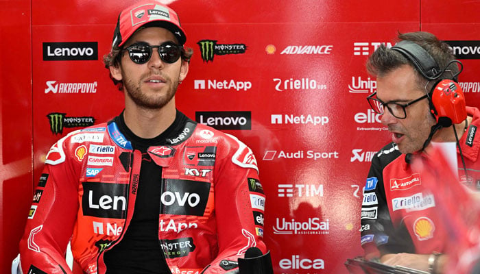 Ducati Lenovo Teams Italian rider Enea Bastianini (L) prepares before a free practice session for the 2024 MotoGP race at Pertamina Mandalika International Circuit in Mandalika, West Nusa Tenggara on September 27, 2024. — AFP