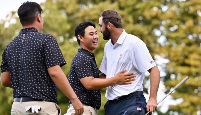 Tom Kim of South Korea and the International Team and Scottie Scheffler of the US Team shake hands after Scheffler and Russell Henley defeated Kim and Sungjae Im 3&2 during Thursdays Four-ball matches on day one of the 2024 Presidents Cup in Montreal, Quebec, Canada on September 26, 2024. — AFP