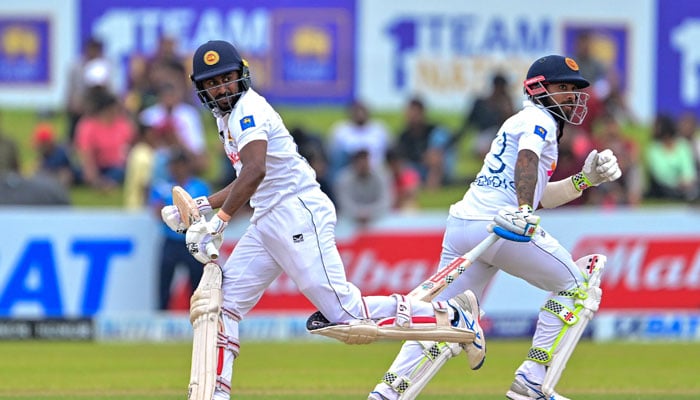 Sri Lankas Kamindu Mendis (L) and Kusal Mendis run between the wickets during the second day of the second Test cricket match between Sri Lanka and New Zealand in Galle on September 27, 2024. — AFP