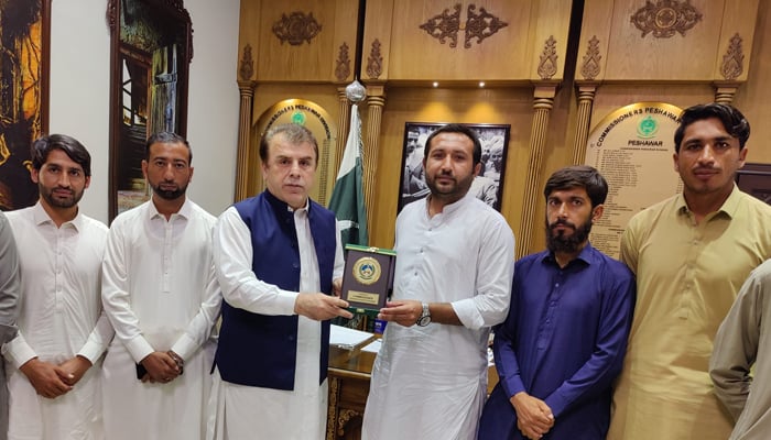 Commissioner Peshawar Division Riyaz Khan Mehsud giving shield to volunteers associated with tribal non-profit organization Asghar Mohmand Foundation for planting thousands of saplings in Peshawar Division Billion Tree Plus plantation campaign seen in this image released on September 26, 2024. — Facebook/@RiazKhanMahsudofficial