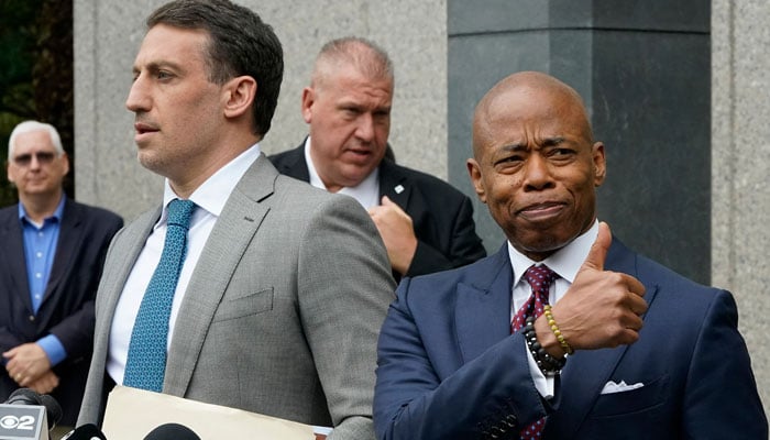 New York City Mayor Eric Adams (R) and his lawyer Alex Spiro (L) speak to the media following a court appearance after being indicted on federal charges of accepting bribes and illegal campaign contributions from Turkish nationals, in New York, September 27, 2024. — AFP