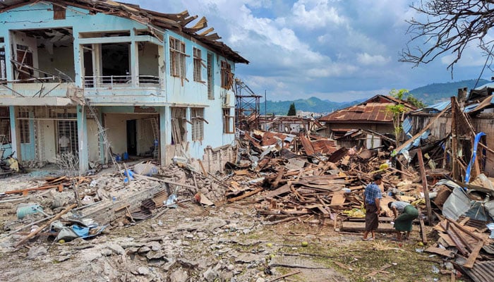 People clean up the debris of destroyed and damaged buildings in the aftermath of bombardments carried out by Myanmars military in Lashio in Myanmar´s northern Shan State on September 24, 2024. — AFP