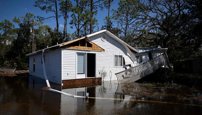 A damaged house on a flooded street is seen after Hurricane Helene made landfall in Steinhatchee, Florida, on September 27, 2024. — AFP