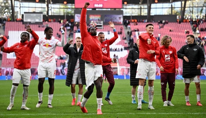 Leipzig’s Benjamin Sesko (centre) and Castello Lukeba (third from right) celebrate with teammates after winning Saturday’s Bundesliga match against Augsburg at the Red Bull Arena in Leipzig. — Reuters/file