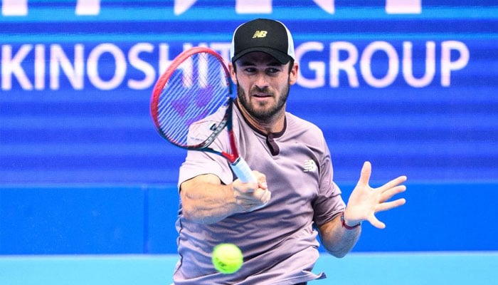 Tommy Paul hits a return against Tomas Machac during their men’s singles match at the Japan Open tennis tournament. — AFP