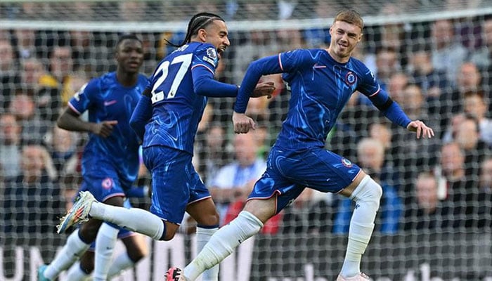 Chelseas English midfielder #20 Cole Palmer (R) celebrates with teammates after scoring his and Chelseas third goal during the English Premier League football match between Chelsea and Brighton and Hove Albion at Stamford Bridge in London on September 28, 2024. — AFP