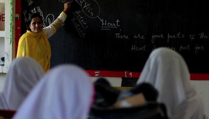 This photograph shows students attending a class at a school on the outskirts of Lahore. — AFP/File