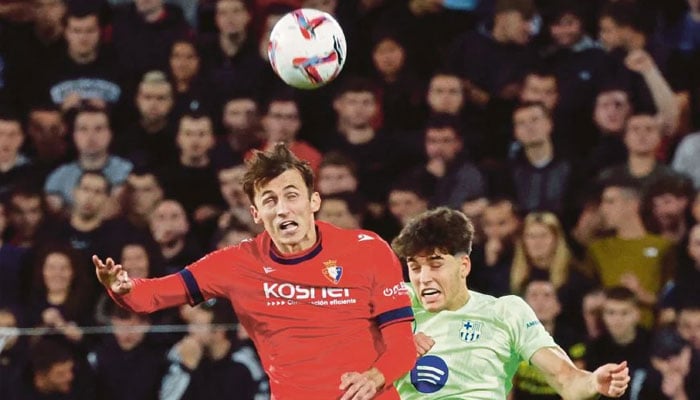 Osasuna’s Ante Budimir (left) in action with Barcelona’s Pau Cubarsi in action during Saturday’s La Liga match at El Sadar Stadium in Pamplona. — Reuters