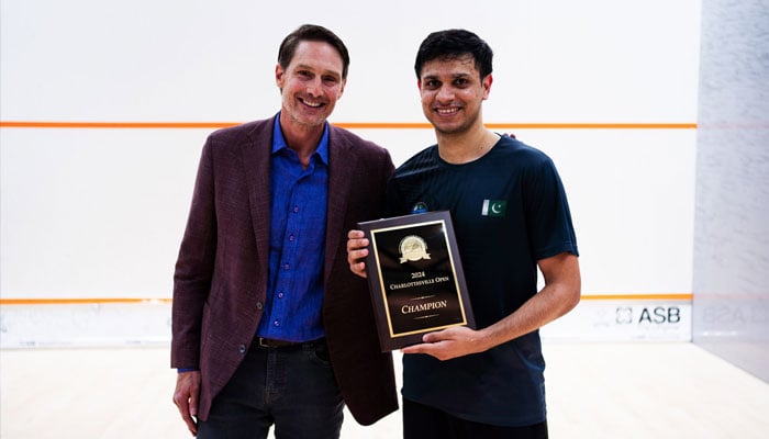 Asim Khan (right) holds his trophy after winning the Charlottesville Open 2024