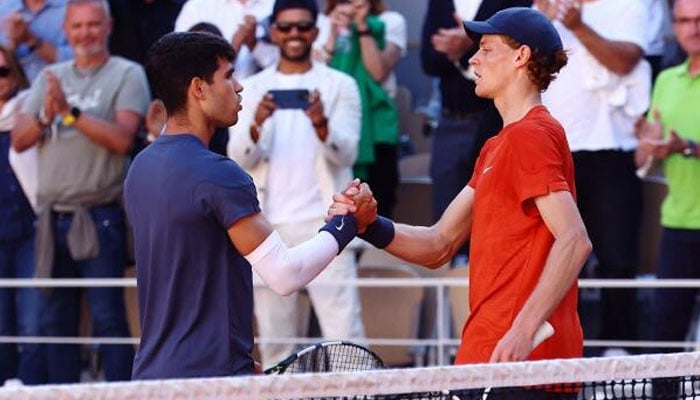 Spains Carlos Alcaraz shakes hands with Italys Jannik Sinner after winning the French Open semifinal. — Reuters