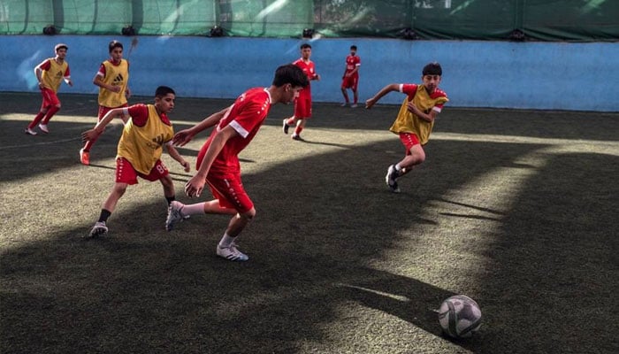 Afghan youths play futsal at a sports complex in Kabul on September 25, 2024. — AFP