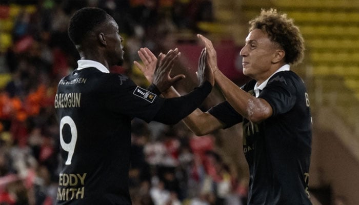 Monaco’s Folarin Balogun celebrates with his teammate Eliesse Ben Seghir after scoring the team’s first goal during their Ligue 1 match against Montpellier in Monaco September 28, 2024. — AFP