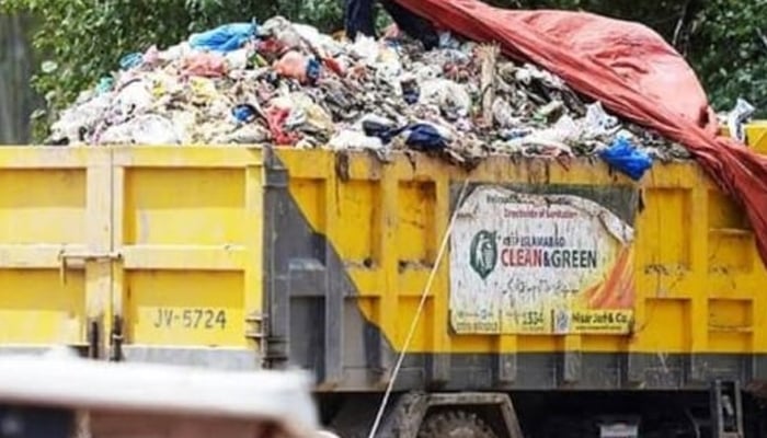 Trucks full of CDA waste are passing through the expressway in Islamabad. — APP/File