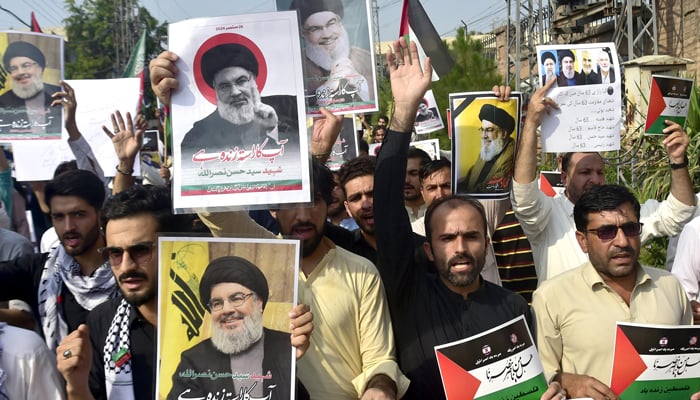 Imamia Students Organisations activists are protesting outside the Peshawar Press Club holding photos of Hezbollah leader Hassan Nasrullah in an Israeli airstrike in Beirut, the capital of Lebanon on September 29, 2024. — INP