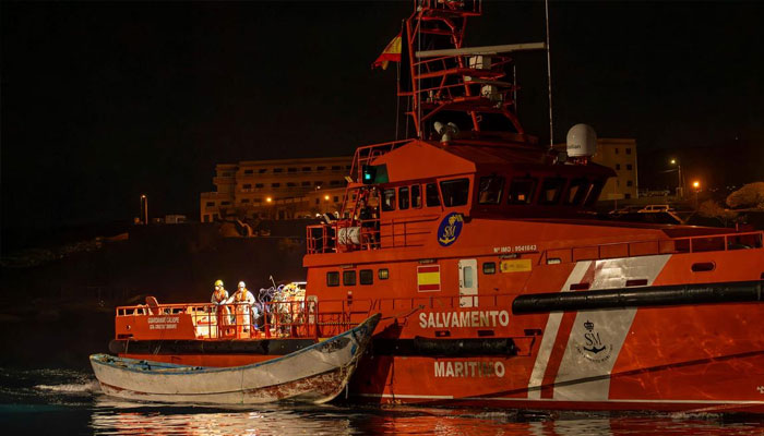 A Spanish Salvamento Maritimo (Sea Search and Rescue agency) vessel tows a boat after 3 “cayuco” boats with around 180 persons onboard arrived at La Restinga port on the Canary island of El Hierro, early on September 19, 2024. — AFP