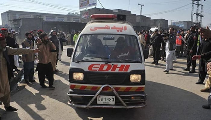 This representational image shows an ambulance arriving as surrounding people make their way. — AFP/File