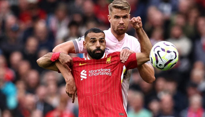 Liverpool scorer Mohamed Salah (left) shields the ball from Brentford defender Kristoffer Ajer at Anfield. — AFP/file