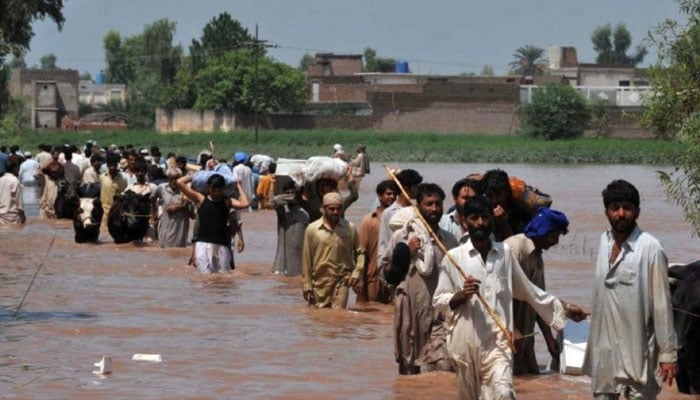 A representational image showing people during evacuation from a flood-struck area. — AFP/File