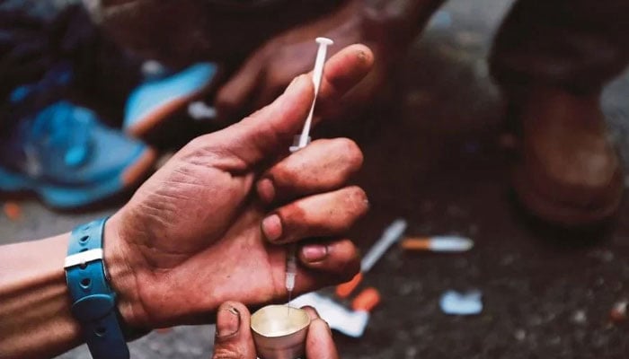 A representational image shows a person preparing an injectable substance. — AFP/File