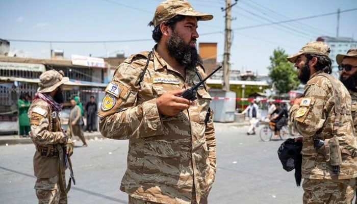 Taliban security personnel stand guard along a street as Afghan Shiite Muslim mourners carry out a procession to celebrate Ashura on the tenth day of the Islamic month of Muharram in Pol-e-Sokhta neighbourhood of Kabul on July 16, 2024. — AFP/file