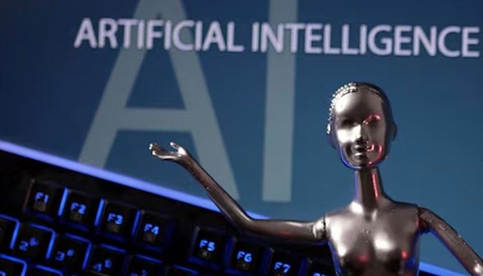 A metallic figure is pictured against the backdrop of AI written in the background in this illustration taken on May 4, 2023. — Reuters