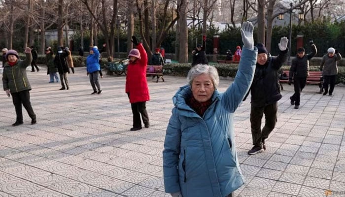 Elderly people dance at a park in Beijing, China on Jan 16, 2024. — Reuters