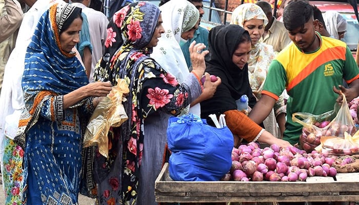 Representational image showing women purchasing onions at a vegetable Market in Lahore, Punjab, on August 31, 2022. — Online