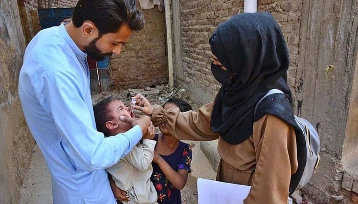 (representational image) A health worker administers polio vaccine to a child during Polio Free Pakistan campaign in Latifabad. — APP/File