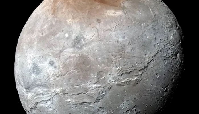 This image provided by NASA shows an enhanced color view of Pluto’s big moon Charon captured by the New Horizons spacecraft, July 14, 2015. — NASA