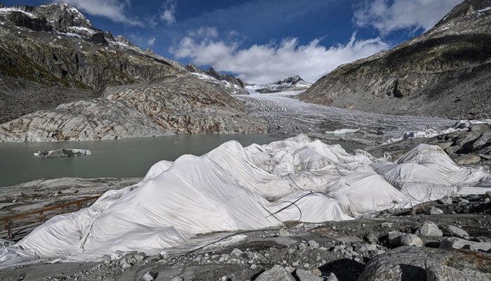 This photograph shows a view of some insulating fabric covering a small part of the Rhone Glacier to prevent it from melting, near Gletsch, in the Swiss Alps, on September 30, 2024. — AFP