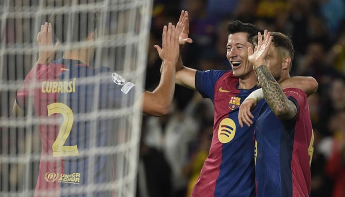 Barcelonas Polish forward Robert Lewandowski celebrates with teammates after netting his second. — AFP/file