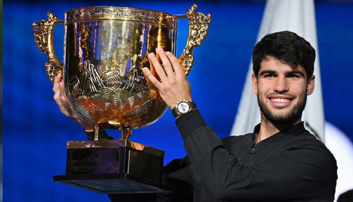 Spains Carlos Alcaraz with the trophy after defeating Italys Jannik Sinner to win the China Open tennis tournament in Beijing. — AFP/file