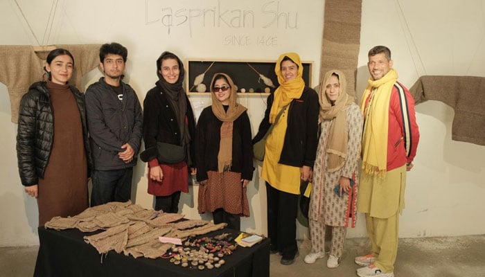 People pose for a group photo with heritage-related work on display. — Supplied