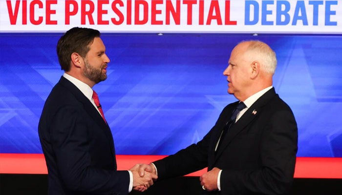 US Senator and Republican vice presidential candidate JD Vance and Minnesota Governor and Democratic vice presidential candidate Tim Walz shake hands at the start of the Vice Presidential debate. —AFP