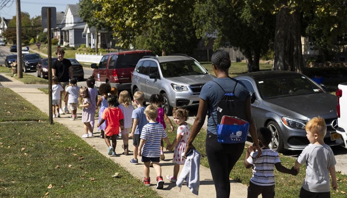 Children and two adults seen walking in this photo.— AFP/file