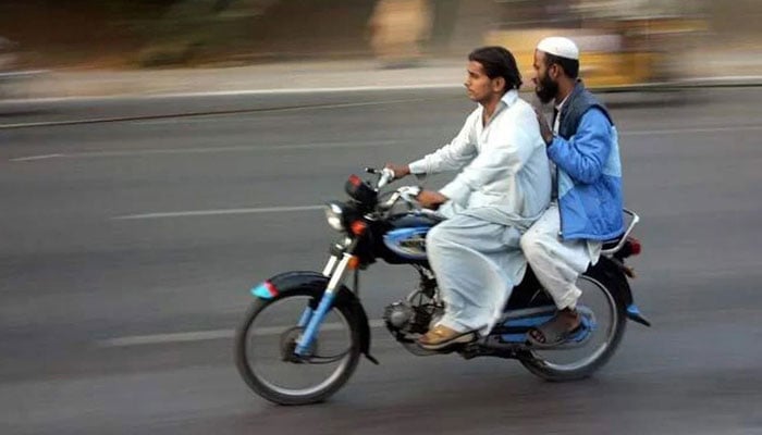 The undated image shows two men riding a motorcycle. — PPI/File