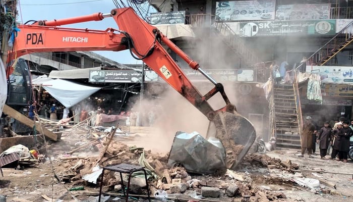 Anti-encroachment operation in progress under the supervision of district administration department, at Karkhano Market in Peshawar on Monday, August 19, 2024. — PPI