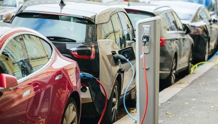 An electric wire is plugged into an electric car in this undated image. — APP/File