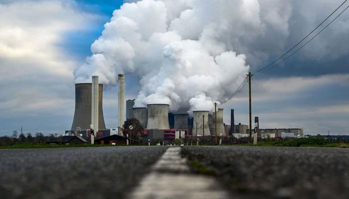 Steam rises from the cooling towers of the power station on November 28, 2023. — AFP