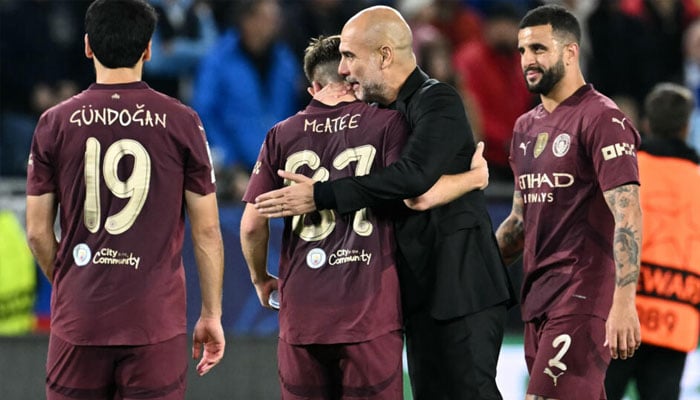 Manchester City manager Pep Guardiola celebrates with his players. — AFP/file